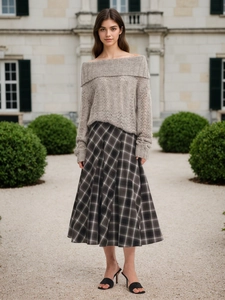 Elegant knit sweater with plaid A-line maxi skirt in a vintage autumn outdoor setting