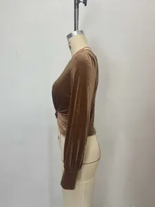 Detail view of brown velvet long sleeve top featuring a twisted waist design on mannequin