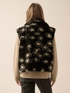 Back view of a black fleece vest with white floral print and lapel collar for women