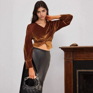 Detailed texture of brown velvet V-neck top with stylish waist knot and long sleeves