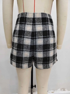 Detailed back view of high-waisted black and white checkered tweed shorts for women