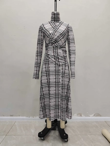 Elegant plaid long sleeve dress with stand collar and waist pleats on mannequin display