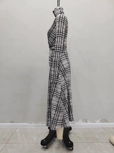 Detail view of the elegant black and white plaid dress fabric with side ruched waist pleats