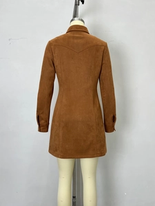 Detail view of the brown faux suede dress featuring a V-shaped seam and buttoned cuffs