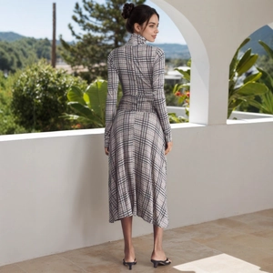 Detail of elegant black and white plaid dress fabric with high neck and long sleeves