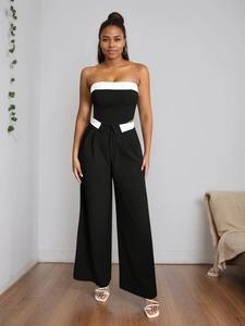 Front view of modern black and white two-piece set with tube top and wide leg trousers