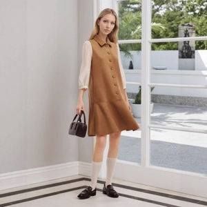 Deep brown sleeveless button-down dress with ruffle hem paired with off-white shirt