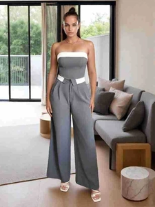 Detail of grey tube top with white trim and matching high-waisted wide-leg trousers