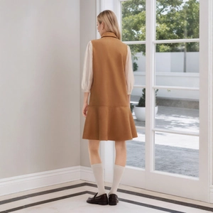 Rear view of elegant suede A-line dress with white puffed sleeves and back slit detail