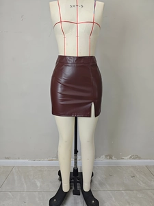 Detailed shot of dark red PU leather mini skirt featuring a side slit and glossy finish