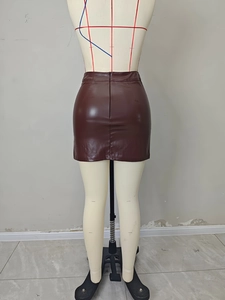 Detail of a dark brown PU leather mini skirt showing back zipper and high waist fit