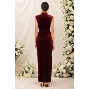 Detailed back view of a slim-fit burgundy velvet evening dress with high slit and collar