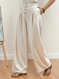 High-waisted wide-leg cotton trousers with decorative buttons and a natural texture