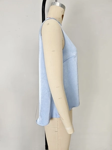 Dettaglio del top senza maniche azzurro con texture a pieghe sottili e cuciture laterali