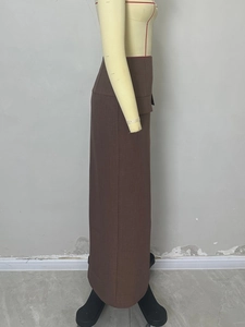Fashionable brown high-waist slit maxi skirt shown on mannequin with textured fabric