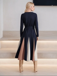 Elegant navy blue A-line dress with long sleeves and contrasting pleated skirt detail