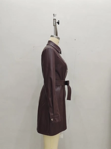 Detail of dark brown PU leather trench coat showing side view waist belt and metal cuff buckles