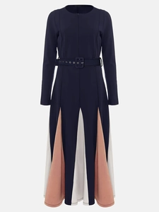 Detailed view of long sleeve navy dress with orange and white pleated colorblock panels