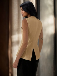 Detailed back view of a beige V-neck vest featuring a stylish signature split hem design