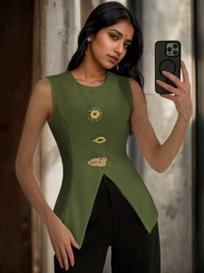 Detail of olive green V-neck vest featuring unique gold sun and eye shaped metal buttons