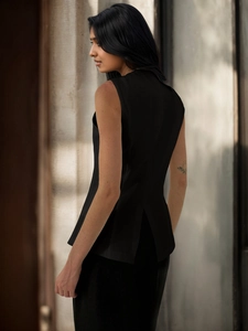 Detail view of the back slit design on a black sleeveless V-neck vest for women