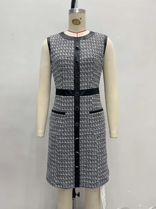 French retro houndstooth tweed sleeveless dress with leather trim shown on a mannequin.