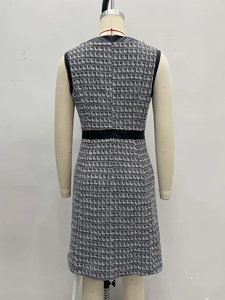 Detailed back view of a French retro houndstooth tweed dress featuring black leather trim