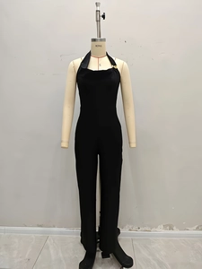 Chic black halter neck jumpsuit with gold buckle detail and slim fit leg design