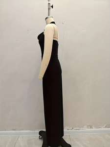 Side view detail of a black halter neck backless jumpsuit with floor-length slim fit design