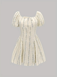 Détail d'une robe d'été à manches bouffantes, col à nœud et fleurs bleu clair