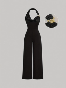 Black halter jumpsuit with cowl neck and gold metal ring detail in wide-leg style