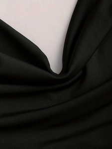 Close-up of high-density black functional fabric with soft sheen and knit texture