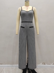 Elegant houndstooth wide-leg jumpsuit with black waist trim and adjustable straps