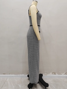 Detail view of the black and white houndstooth fabric and side zipper on the fitted dress