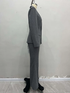 Side view of gray plaid business suit with structured blazer and straight trousers