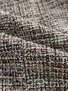 Gros plan sur la texture du tissu tweed multicolore avec fils métalliques et tissage