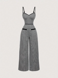 Detailed macro view of houndstooth plaid jumpsuits with side zipper and pocket accents
