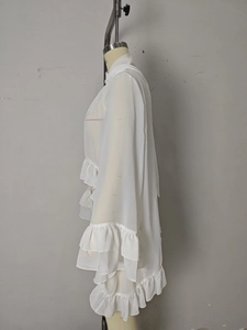 Detail of white ruffle high neck chiffon blouse with layered sleeve ruffles