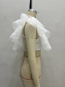White tiered lace mesh ruffle bolero shrug for women shown on a fashion mannequin