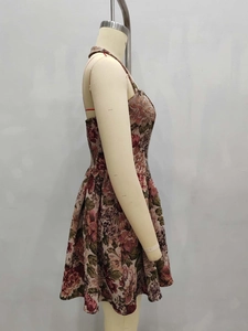 Detailed side view of floral mini dress showing textured jacquard fabric and waist cut