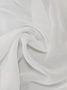Detail shot of white semi-transparent chiffon fabric with soft pleats and smooth texture