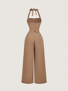Detail view of khaki halter jumpsuit back featuring bow tie neck and invisible zipper