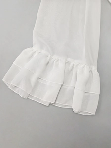 Detailed view of white sheer chiffon fabric featuring elegant double-layered ruffles