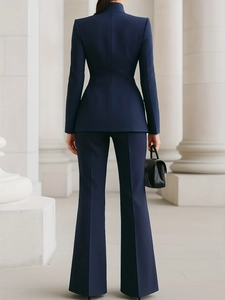Slim fit navy blue women's business suit set with blazer and flared trousers from behind