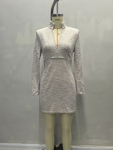 Close-up of elegant V-neck tweed mini dress with textured woven fabric in grey and white
