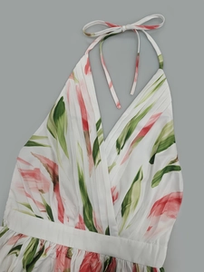 Detailed view of white floral dress with V-neckline and elegant pink flower patterns