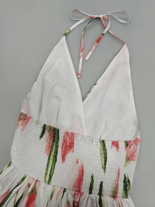 Detail view of the smocked waist and halter neck floral print summer dress