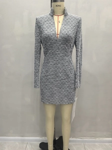 Detail of grey tweed fabric texture and deep V-neckline on a slim fit long sleeve dress