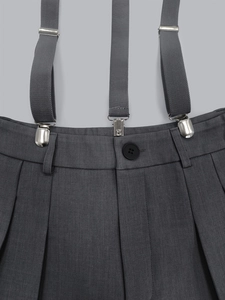 Detail of adjustable straps and button waist on dark grey twill casual suspender pants