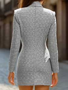 Detail view of the back of a grey tweed dress with professional slim-fit waist and textured fabric